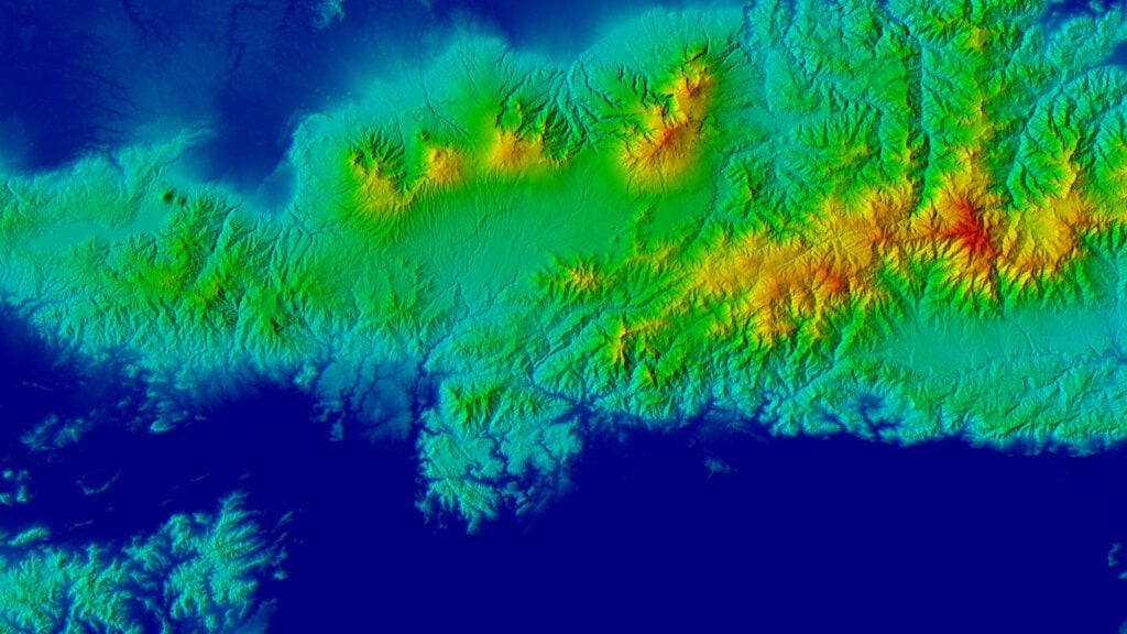 Topographical digital elevation model highlighting terrain undulations in vivid colors to indicate elevation gradients, useful for geospatial analysis.